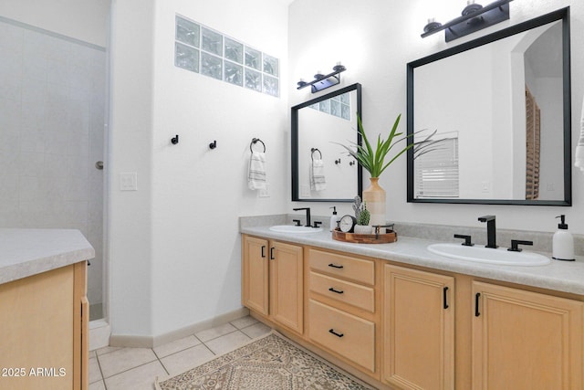 18161 N 63rd Ln, Glendale, AZ 85308 - bathroom with a sink, double vanity, a tile shower, and tile patterned floors