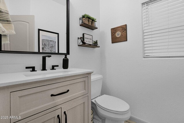 18161 N 63rd Ln, Glendale, AZ 85308 - bathroom with toilet, baseboards, and vanity