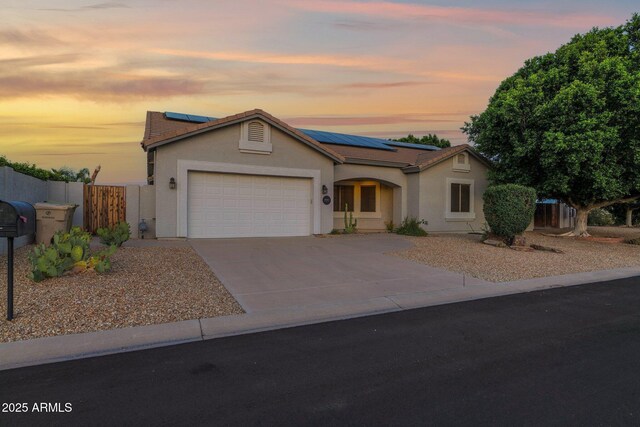 18161 N 63rd Ln, Glendale, AZ 85308 - ranch-style house with an attached garage, a tiled roof, fence, and solar panels
