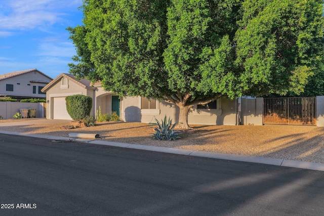 18161 N 63rd Ln, Glendale, AZ 85308 - view of front of house with concrete driveway, a garage, stucco siding, and fence