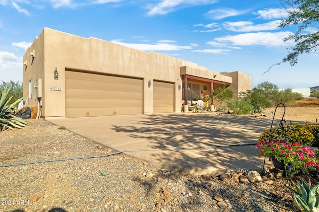 southwest-style home featuring a garage