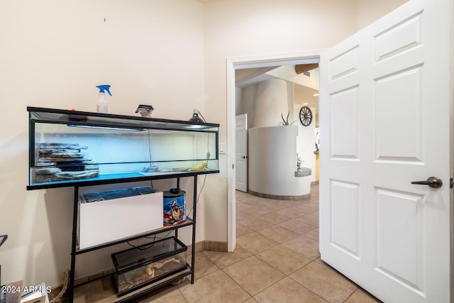 interior space with water heater and light tile patterned flooring