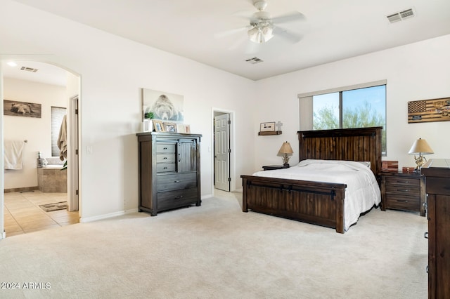 carpeted bedroom with ceiling fan and connected bathroom