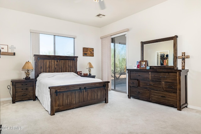 carpeted bedroom featuring access to outside, multiple windows, and ceiling fan