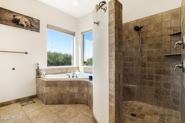 bathroom with tile patterned floors and shower with separate bathtub