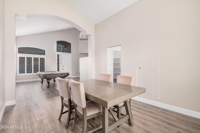 dining space with high vaulted ceiling, light wood-type flooring, and billiards