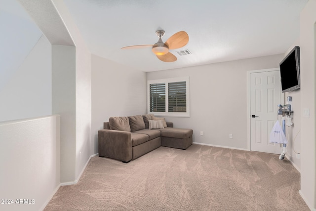 carpeted living room with ceiling fan