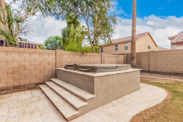 view of patio / terrace with a hot tub