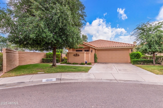 view of front of property with a tiled roof, an attached garage, stucco siding, and concrete driveway