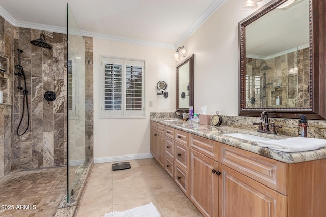bathroom with ornamental molding, a tile shower, double vanity, and baseboards