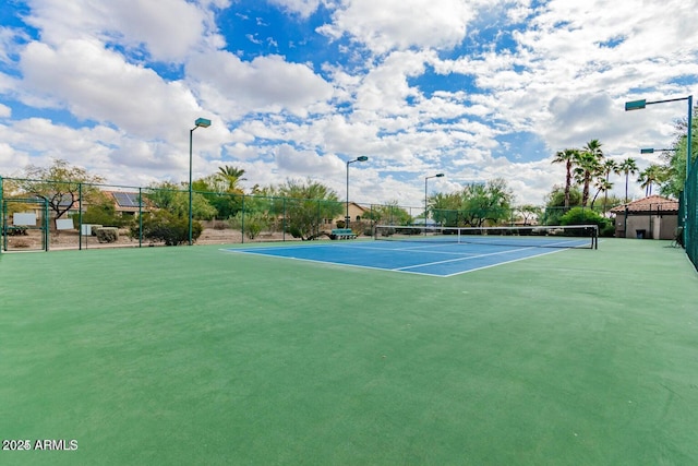 view of tennis court with fence