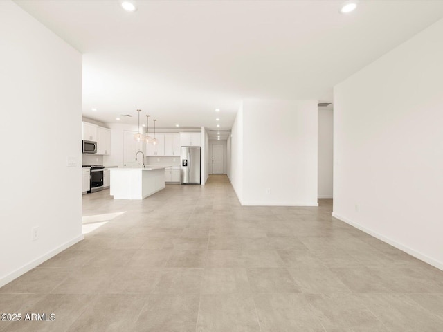 unfurnished living room with sink