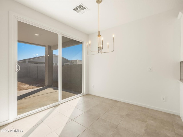 unfurnished dining area with a chandelier and light tile patterned floors