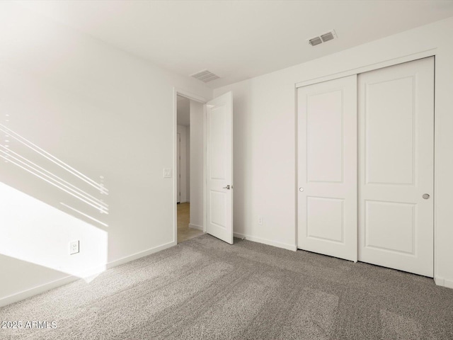 unfurnished bedroom with carpet floors and a closet