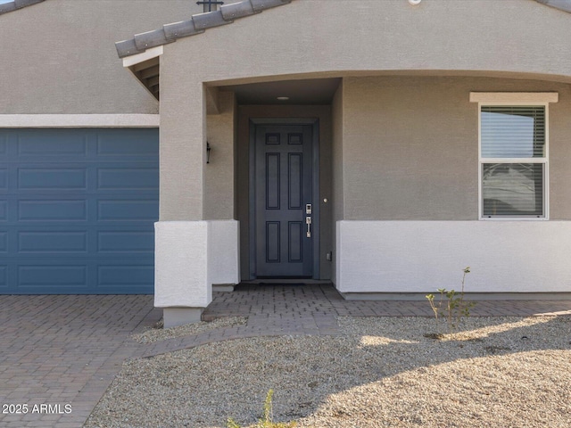 doorway to property with a garage