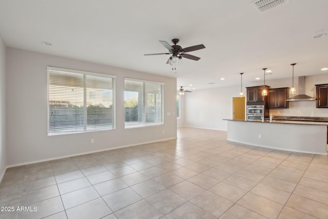 unfurnished living room featuring ceiling fan and light tile patterned flooring