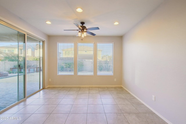 spare room featuring ceiling fan and light tile patterned floors