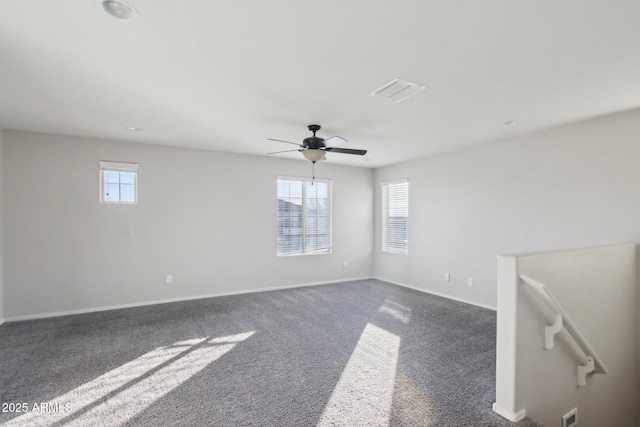 spare room with dark carpet and ceiling fan