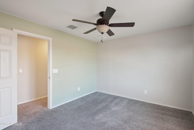 empty room with ceiling fan and carpet