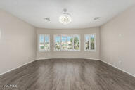 interior space with wood finished floors, a wealth of natural light, and baseboards