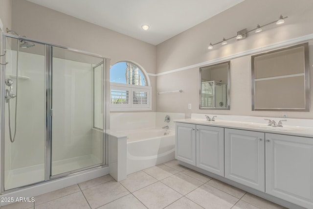 full bath with a garden tub, a stall shower, tile patterned flooring, and a sink