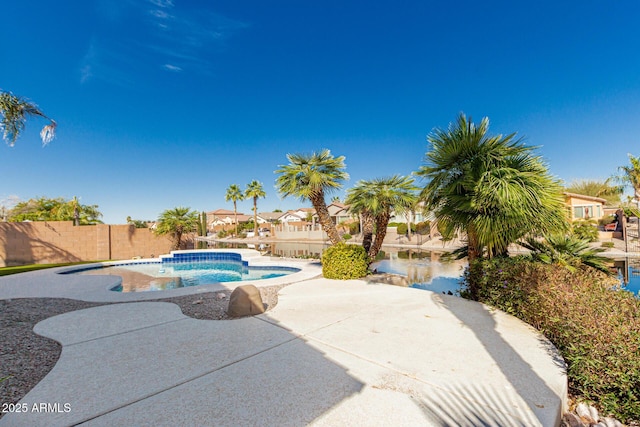 view of swimming pool featuring a patio, fence, and a fenced in pool