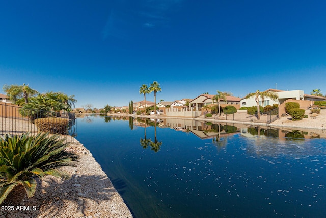 property view of water with a residential view and fence