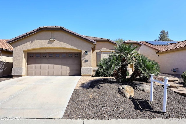 view of front of property featuring a tile roof, a garage, driveway, and stucco siding