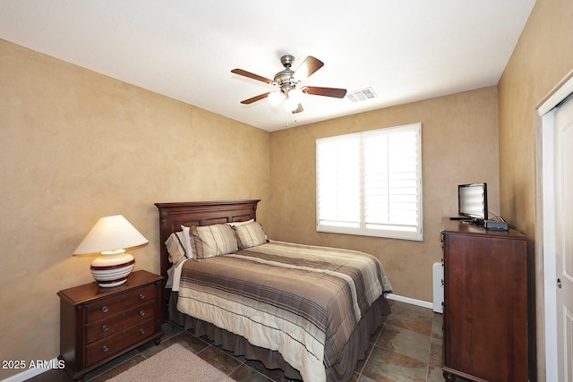 bedroom featuring visible vents, baseboards, and a ceiling fan