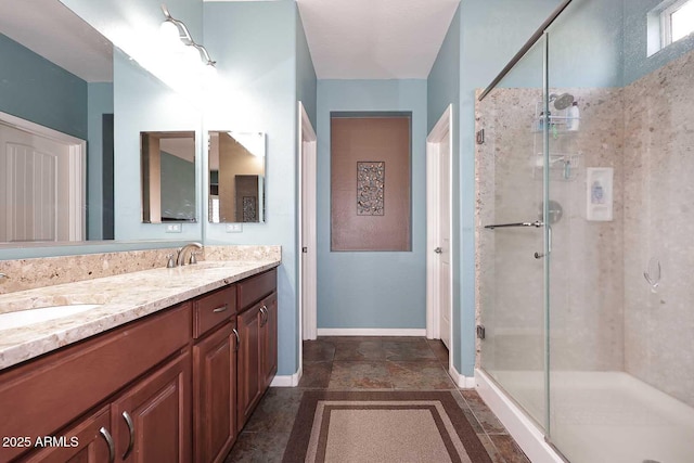 bathroom featuring a sink, double vanity, and a shower stall