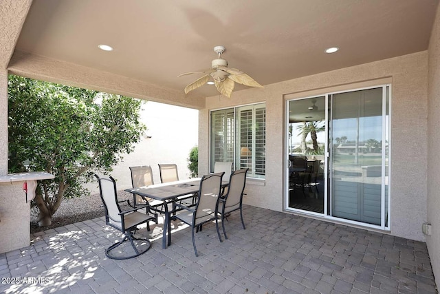 view of patio featuring outdoor dining area and ceiling fan