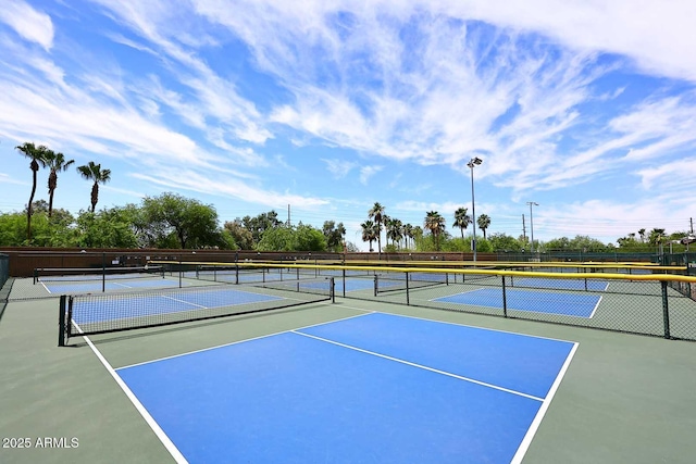 view of tennis court with fence