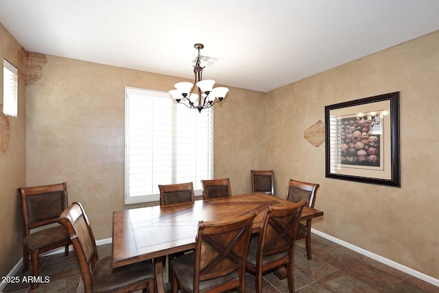 dining room featuring visible vents, baseboards, and a chandelier