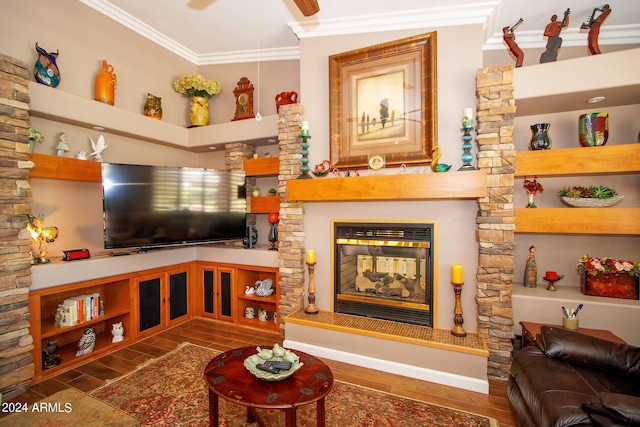 living area with ceiling fan, wood finished floors, a multi sided fireplace, and ornamental molding