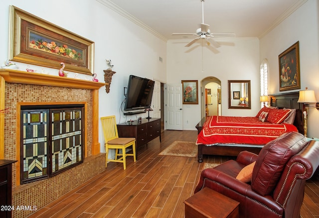 bedroom with arched walkways, visible vents, ornamental molding, and wood finished floors