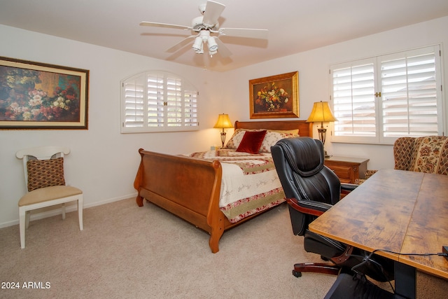 carpeted bedroom featuring multiple windows, a ceiling fan, and baseboards