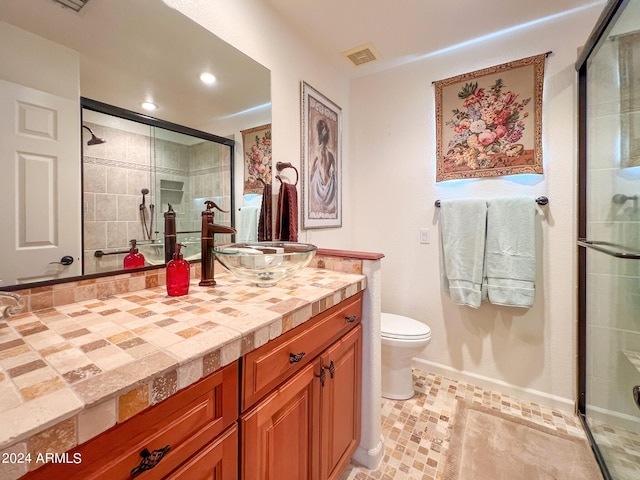 full bathroom featuring visible vents, toilet, a stall shower, and vanity