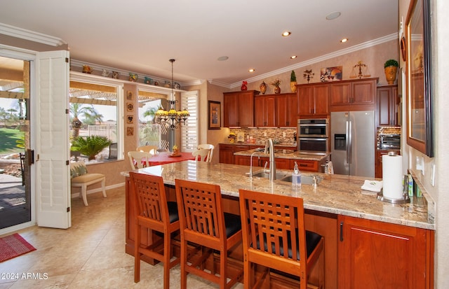 kitchen with a sink, a peninsula, crown molding, and stainless steel appliances