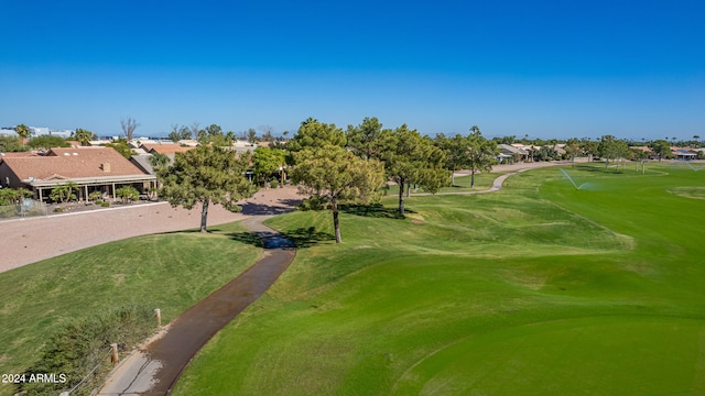 view of home's community with golf course view and a yard