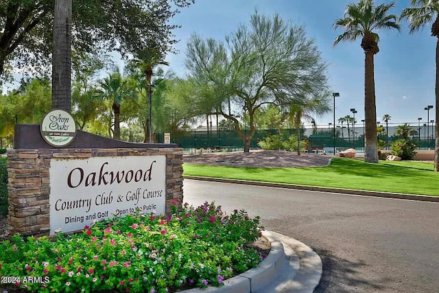 community sign with a lawn and fence