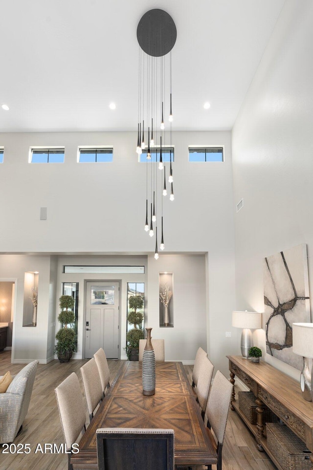 2656 E Oriole Dr, Gilbert, AZ 85297 - dining area with a towering ceiling, wood-type flooring, and a wealth of natural light