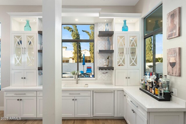 2656 E Oriole Dr, Gilbert, AZ 85297 - bar featuring sink, backsplash, white cabinetry, and plenty of natural light