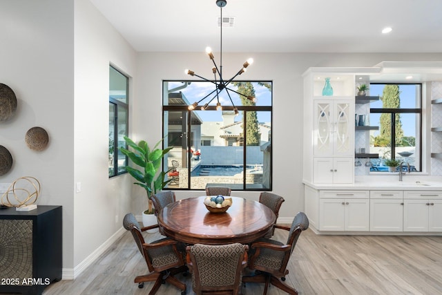 2656 E Oriole Dr, Gilbert, AZ 85297 - dining room with light hardwood / wood-style flooring, sink, and a chandelier