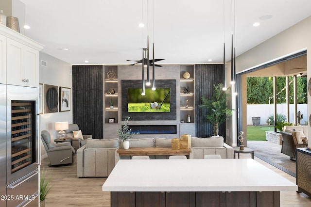 2656 E Oriole Dr, Gilbert, AZ 85297 - living room with light wood-type flooring, built in shelves, and beverage cooler