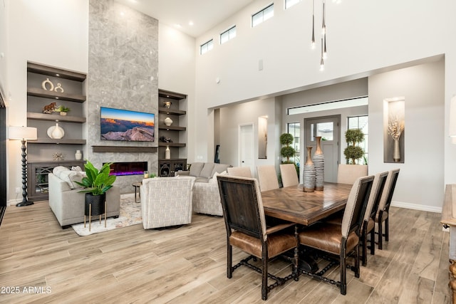 2656 E Oriole Dr, Gilbert, AZ 85297 - dining area with light wood-type flooring, a high end fireplace, and built in features