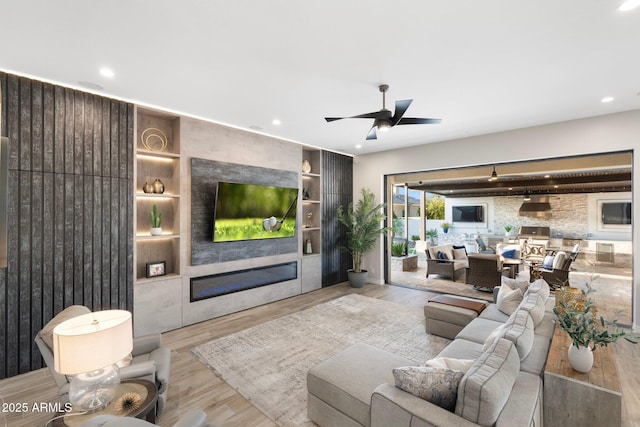 2656 E Oriole Dr, Gilbert, AZ 85297 - living room featuring light hardwood / wood-style floors, ceiling fan, and built in features