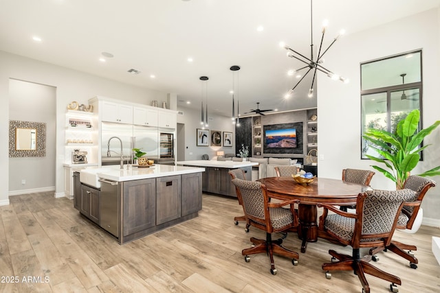 2656 E Oriole Dr, Gilbert, AZ 85297 - kitchen featuring a center island with sink, dark brown cabinets, sink, and decorative light fixtures