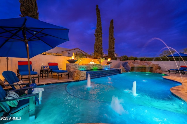 2656 E Oriole Dr, Gilbert, AZ 85297 - pool at dusk featuring pool water feature, a patio, and a jacuzzi