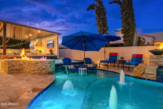 2656 E Oriole Dr, Gilbert, AZ 85297 - pool at dusk featuring a patio area, a fire pit, and pool water feature