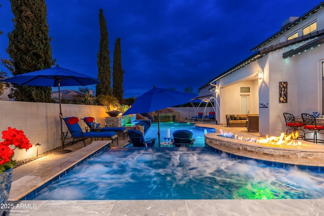 2656 E Oriole Dr, Gilbert, AZ 85297 - pool at night featuring pool water feature and a fire pit